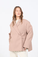 Woman wearing a beige coat on a white background